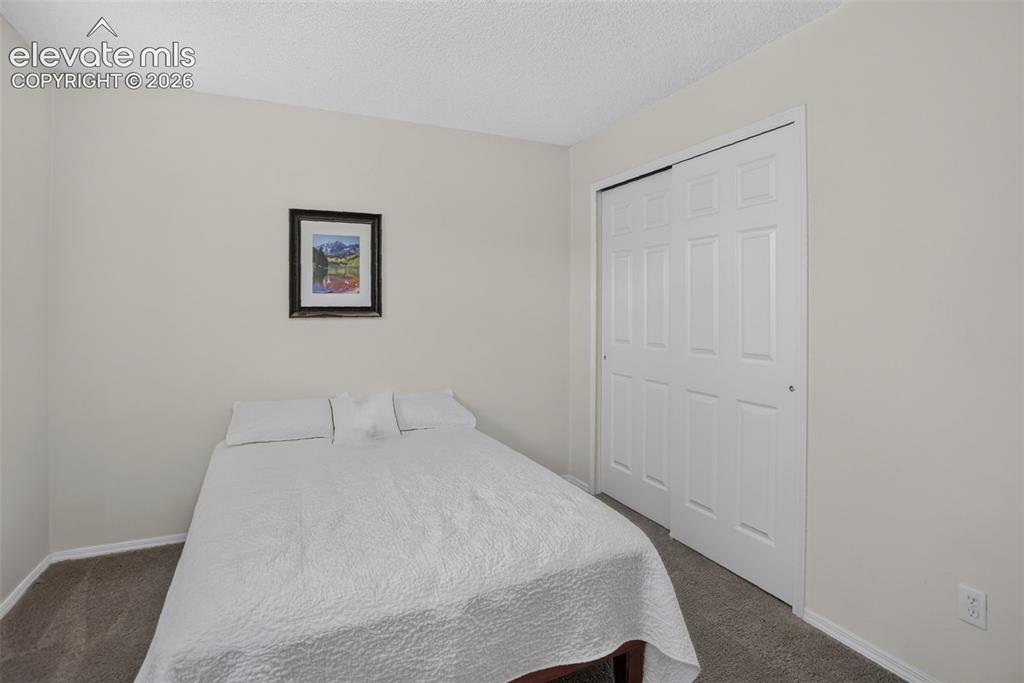 Image 42 of 49: Interior room featuring neutral gray carpeting and white painted walls