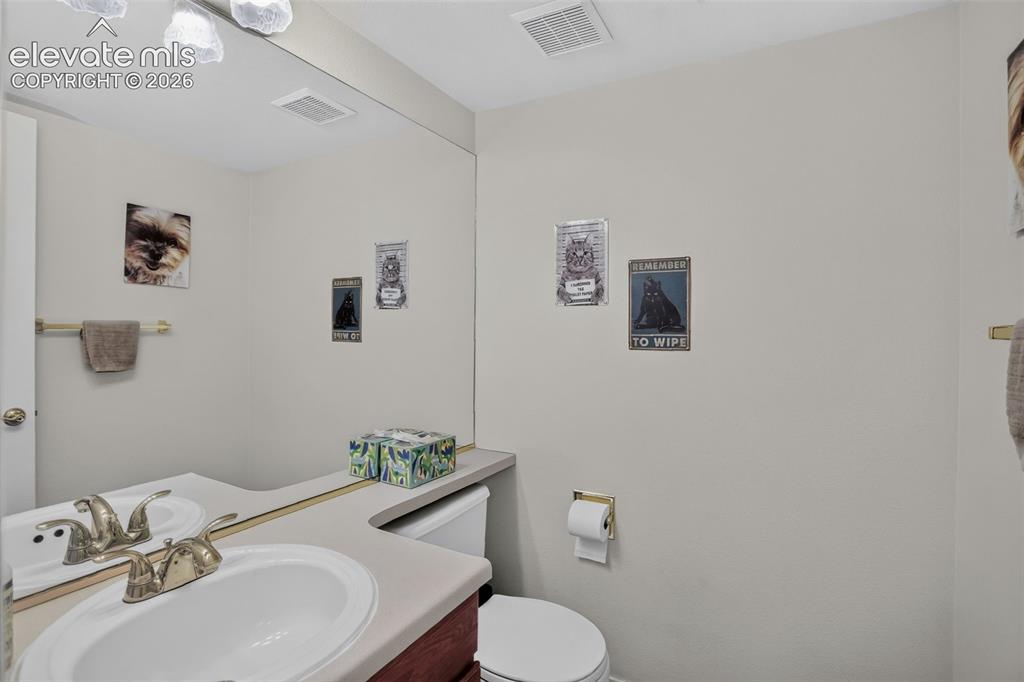Image 44 of 49: Light-colored walls with textured ceiling, featuring a bi-fold closet door