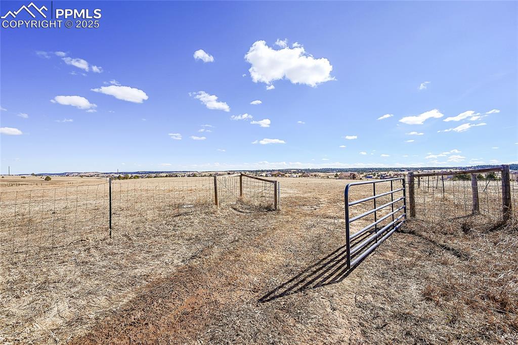 Image 14 of 32: View of yard featuring a rural view and a gate