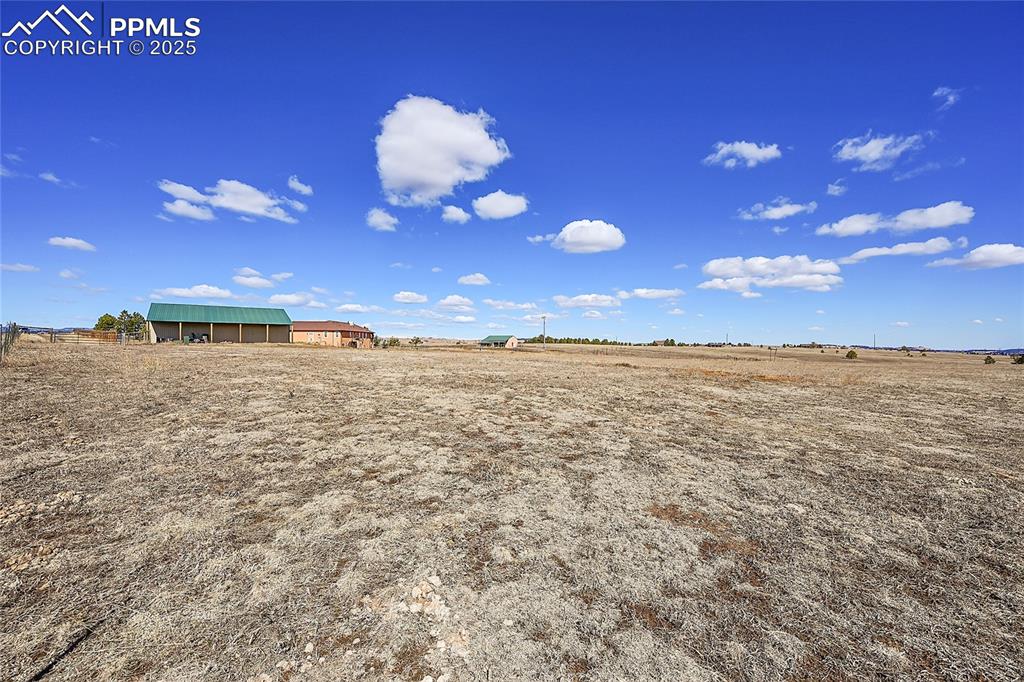 Image 16 of 32: View of yard featuring an outbuilding and a rural view