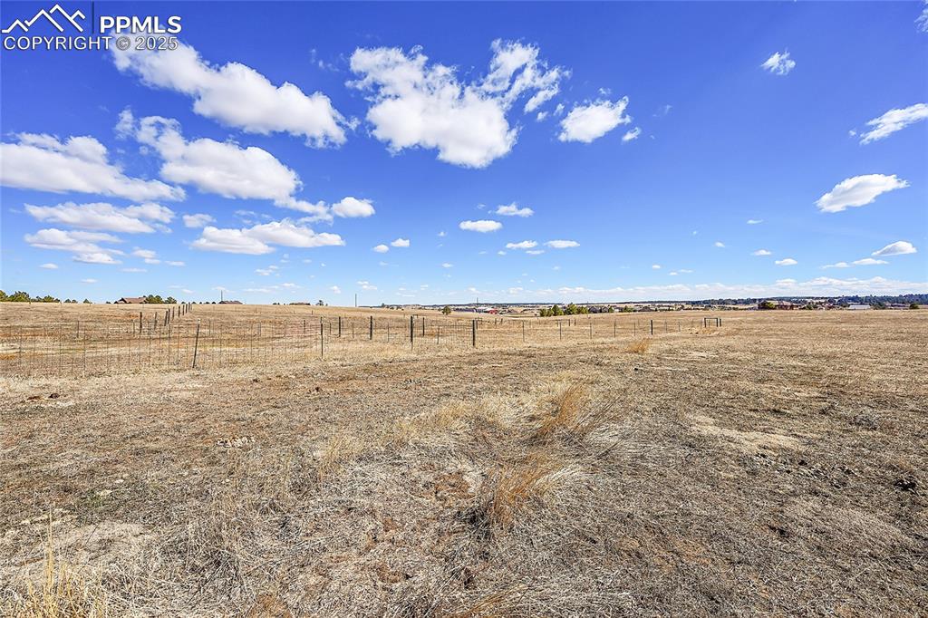 Image 18 of 32: View of yard featuring a rural view and fence