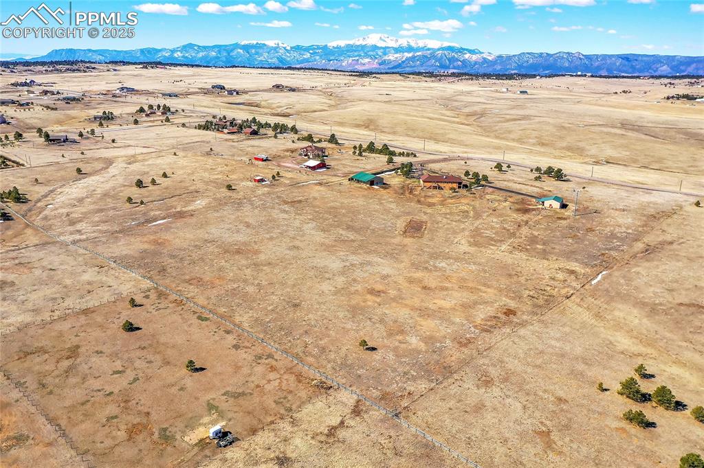 Image 24 of 32: Birds eye view of property with a rural view, a mountain view, and view of 