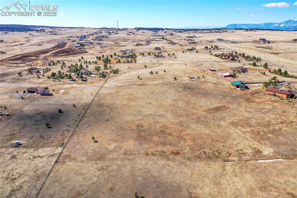 Image 25 of 32: Birds eye view of property featuring a mountain view and view of desert