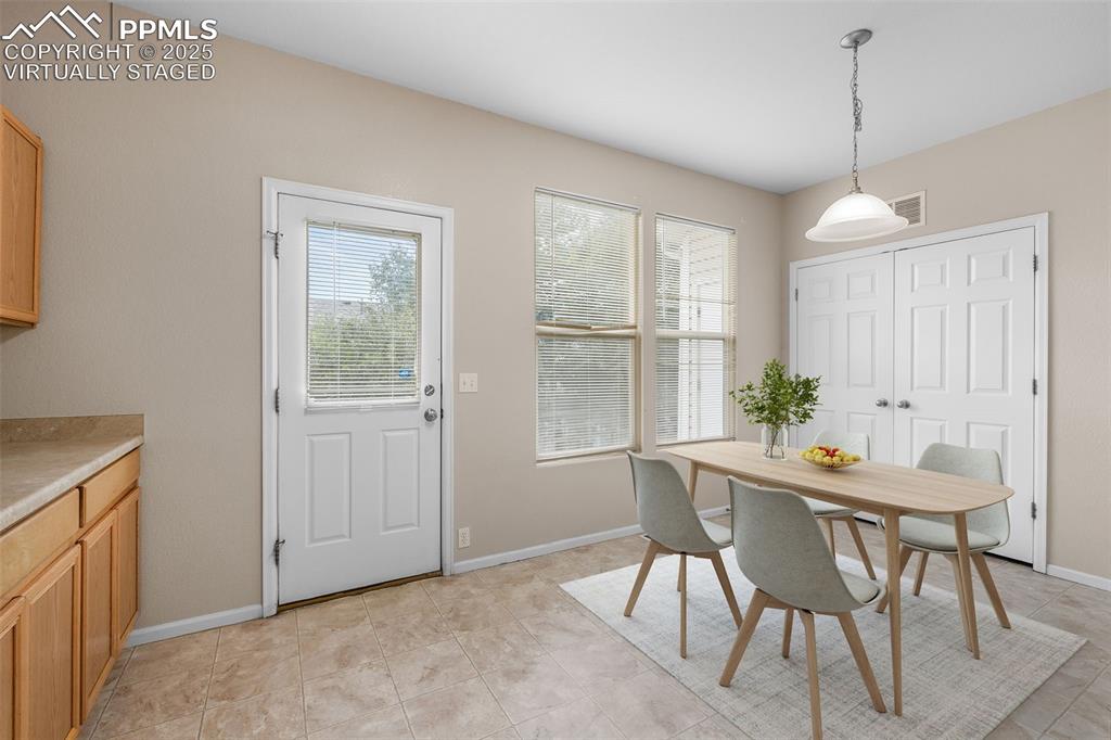 Image 18 of 38: *Virtually Staged* Dining room with plenty of natural light and light tile 