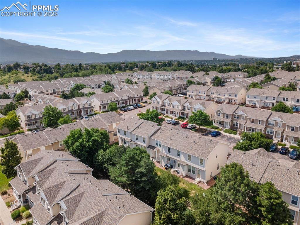 Image 34 of 38: Aerial perspective of suburban area with mountains