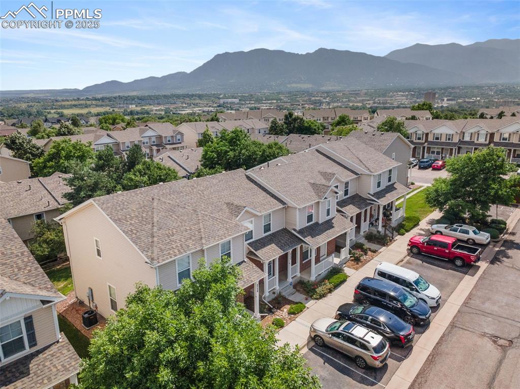 Image 36 of 38: Aerial perspective of suburban area with a mountain backdrop
