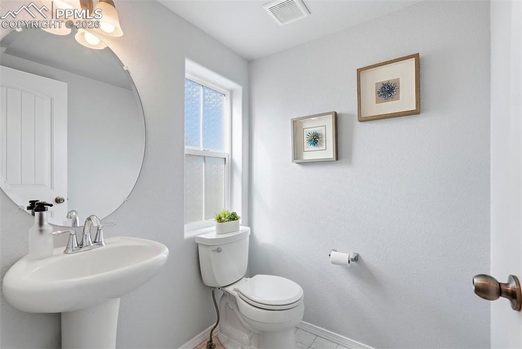 Image 13 of 33: half bath off stair landing