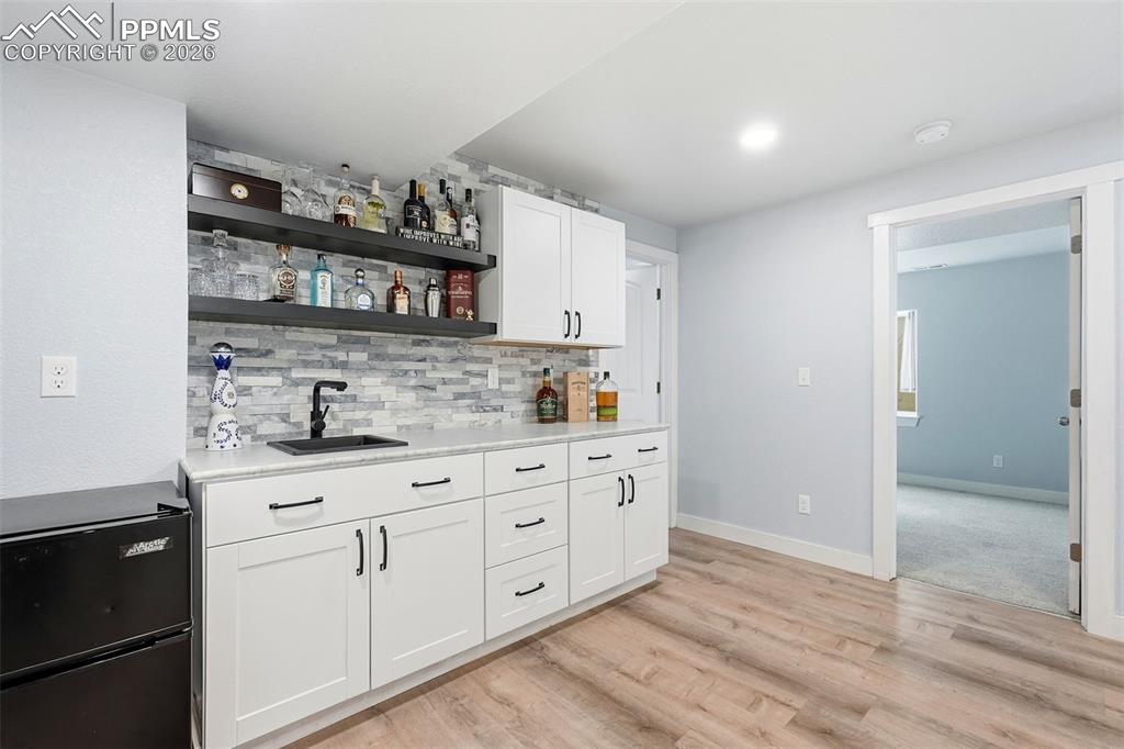 Image 26 of 33: wet bar in basement