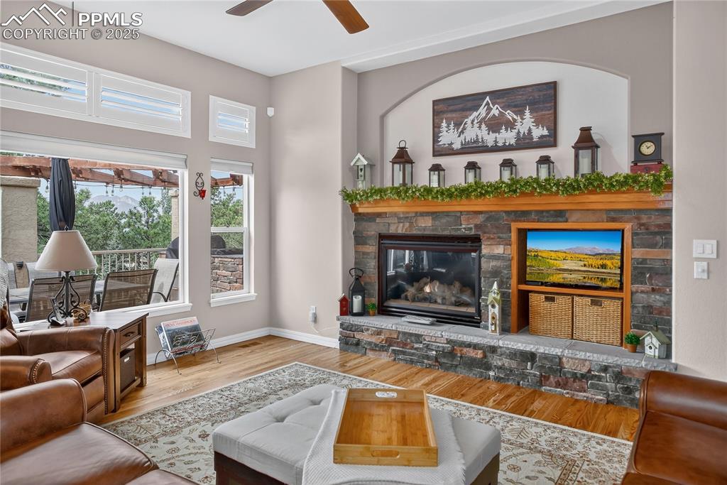 Image 10 of 45: Living room looks out to rear deck