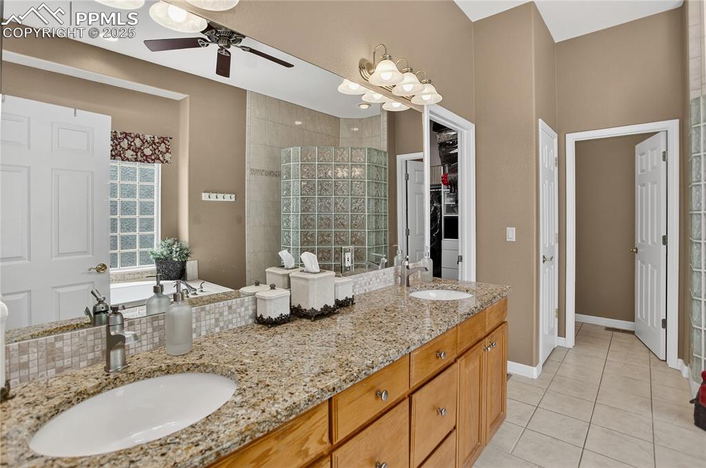 Image 18 of 45: 5-piece primary bath has granite countertops.