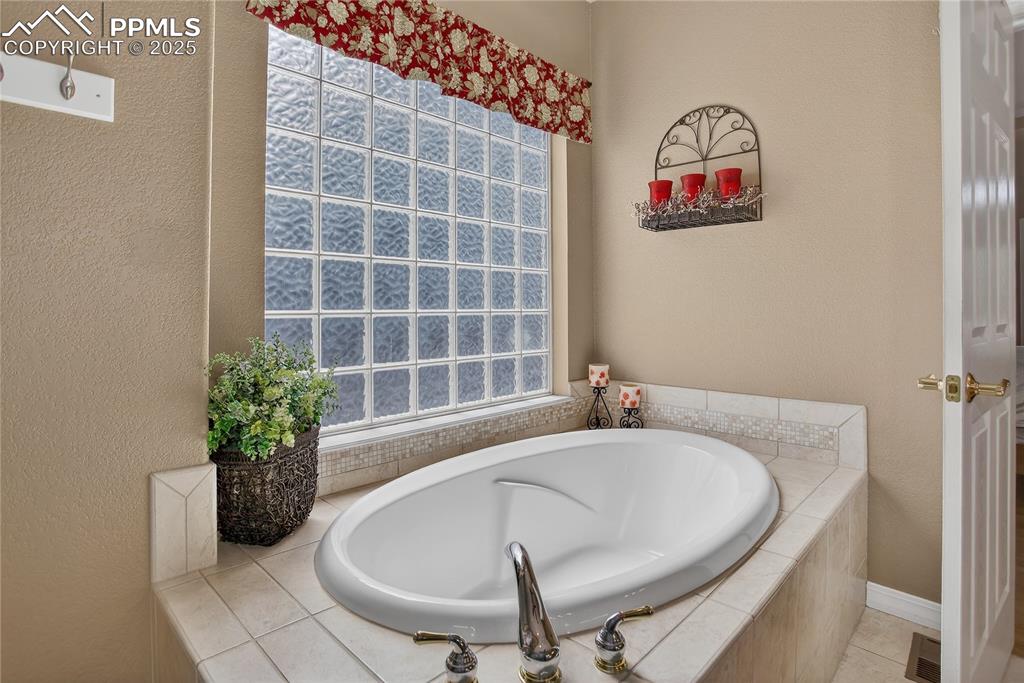 Image 19 of 45: En-suite bath has a walk-in shower and soaking tub!