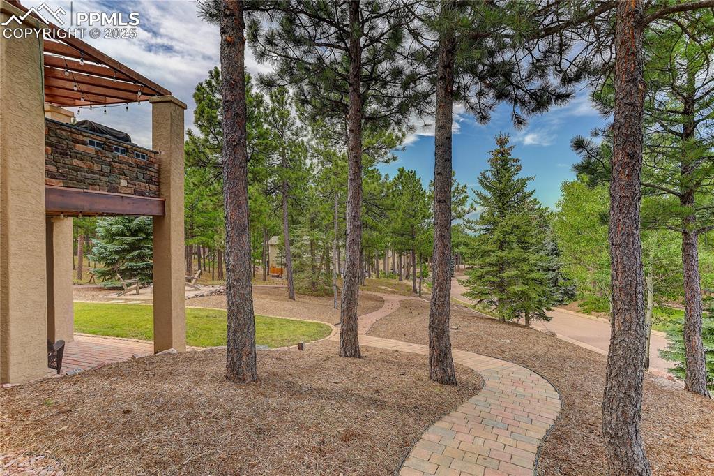 Image 39 of 45: Paver walkway links front and rear areas of the 1.1 acre DOUBLE LOT