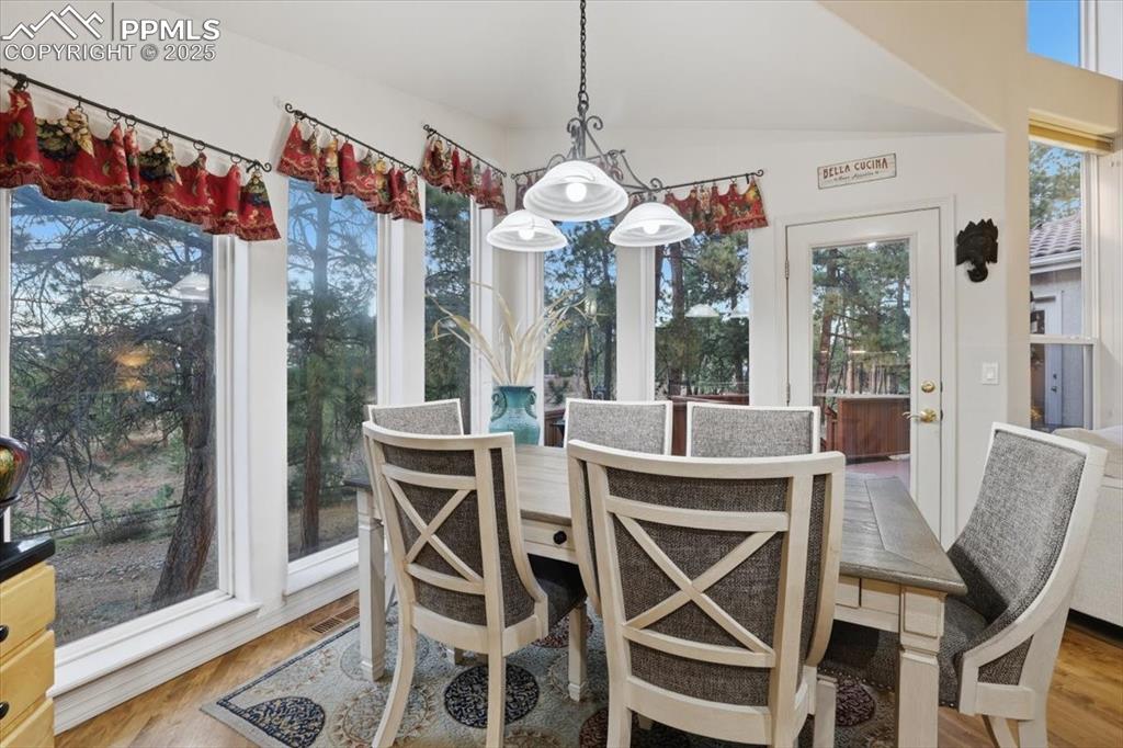 Image 10 of 49: Informal dining area with walk-out onto patio