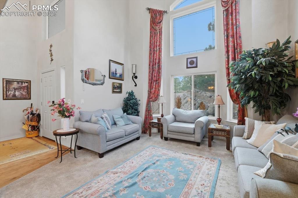 Image 2 of 49: Secondary living/sitting room off of entry with tons of natual light