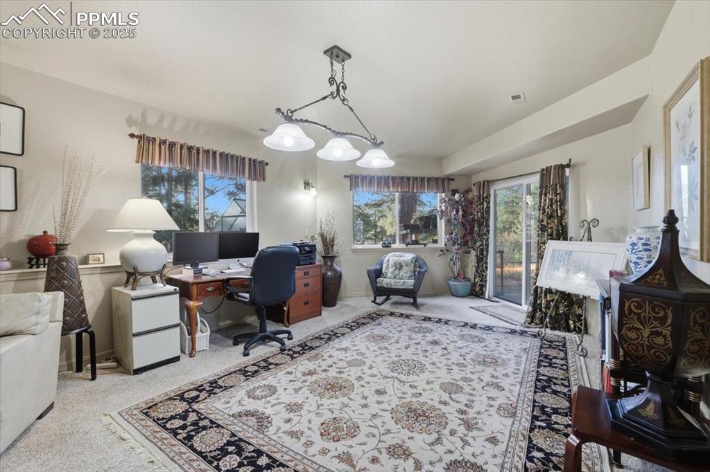 Image 23 of 49: Basement family room with walk-out onto lower patio