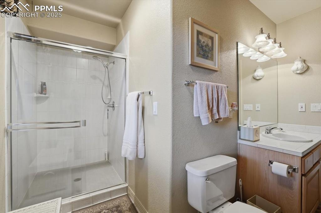 Image 26 of 49: Basement family room with walk-out onto lower patio