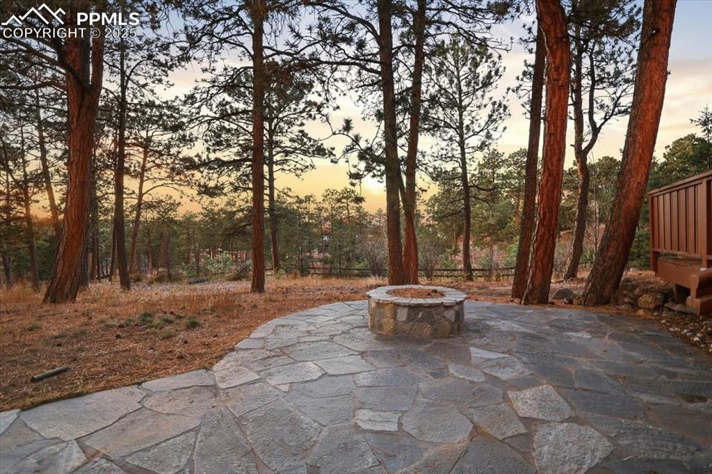 Image 40 of 49: Firepit off of lower patio