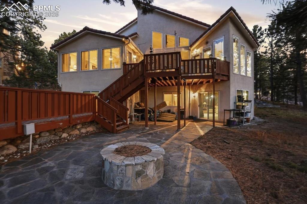 Image 43 of 49: Firepit off of lower patio