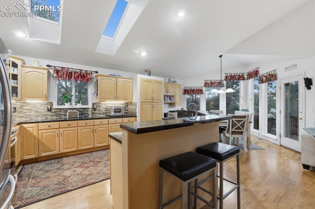 Image 6 of 49: Huge kitchen with expansive granite countertops, high-end appliances.