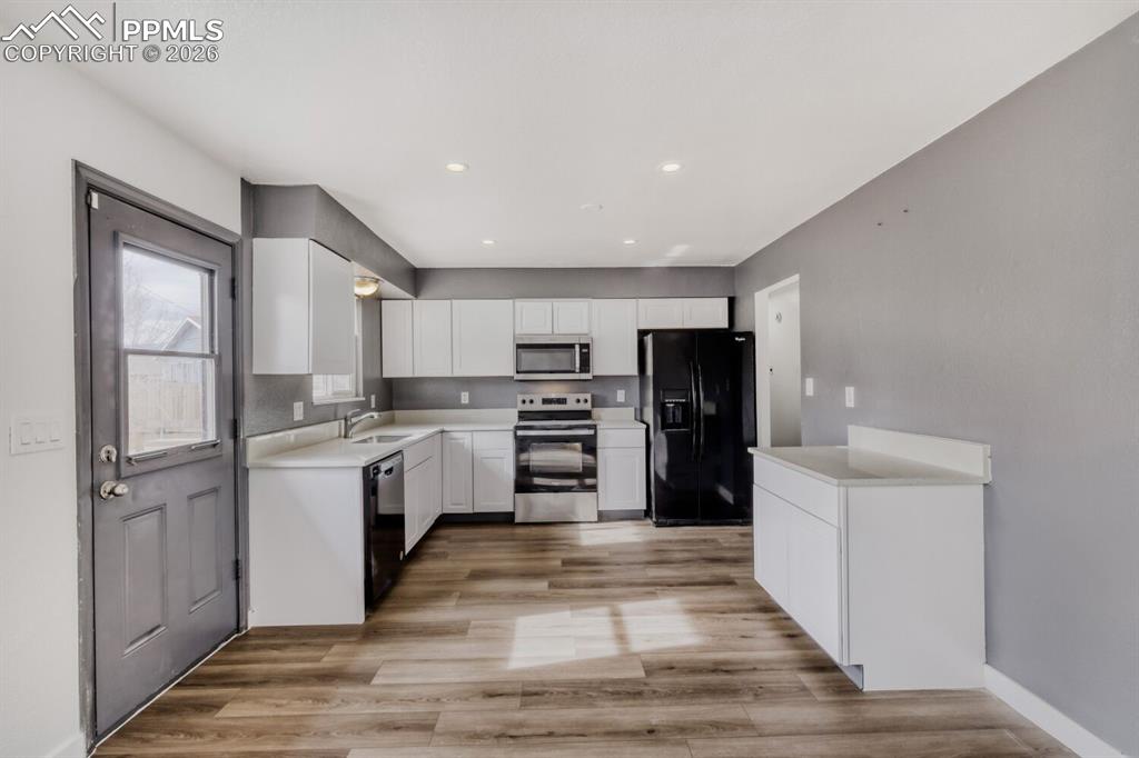 Image 10 of 36: Kitchen featuring new cabinets and quartz countertops