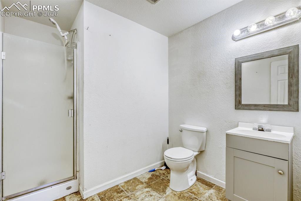 Image 29 of 36: Lower level bathroom en-suite with fifth bedroom