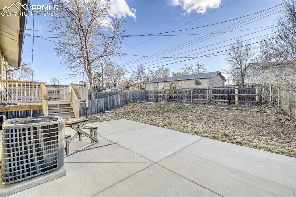 Image 31 of 36: New concrete back patio and AC