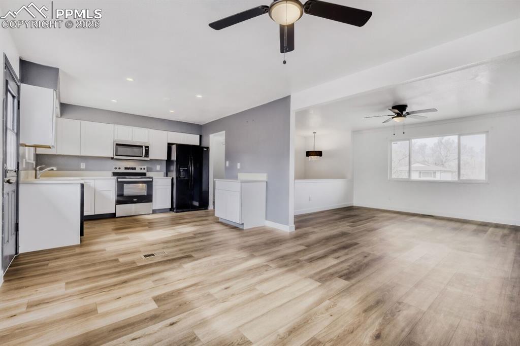 Image 8 of 36: View of kitchen, dining and living rooms