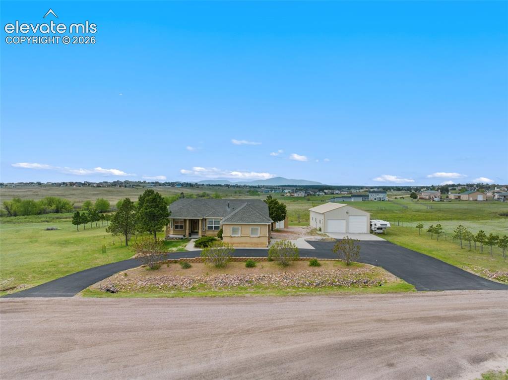 Image 1 of 49: Beautiful stucco home with attached 3-car garage, large shop, storage shed,