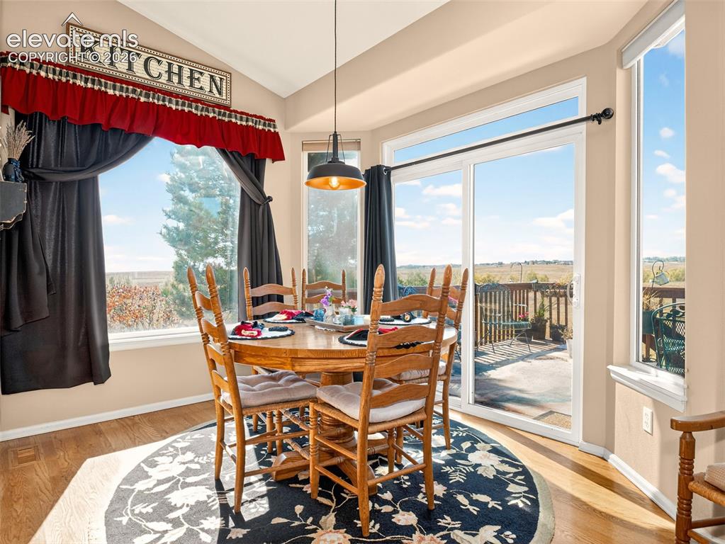 Image 13 of 49: Informal dining area with glass sliding door to the deck and views of Pikes