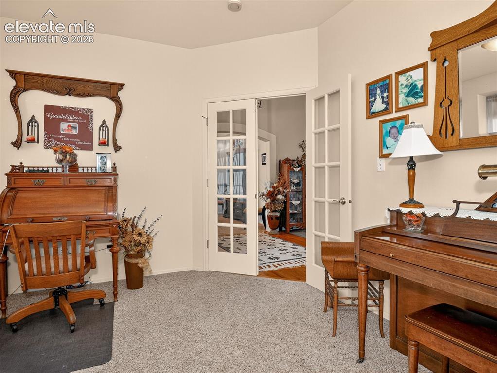 Image 19 of 49: Office space (could be converted into a 5th bedroom) with carpet and French