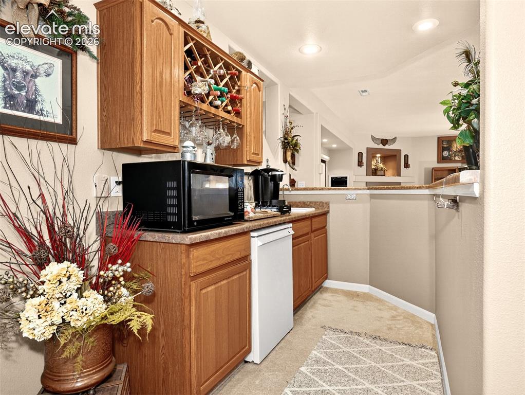 Image 31 of 49: Wet bar in basement.