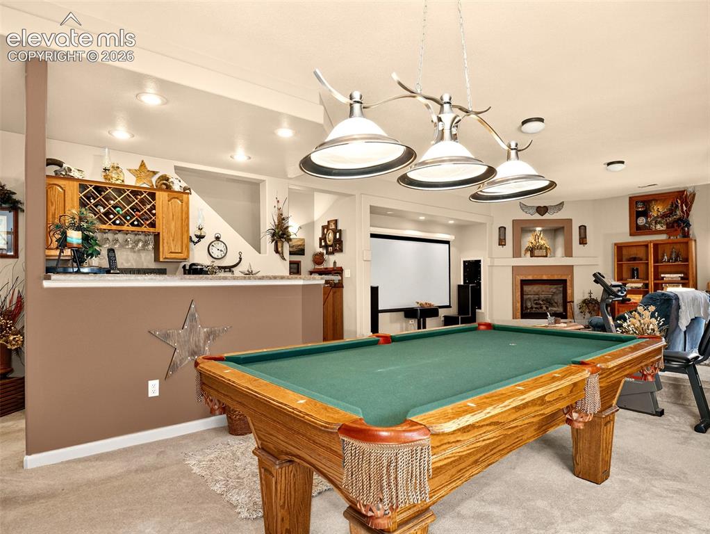 Image 32 of 49: Pool table in basement entertainment area.