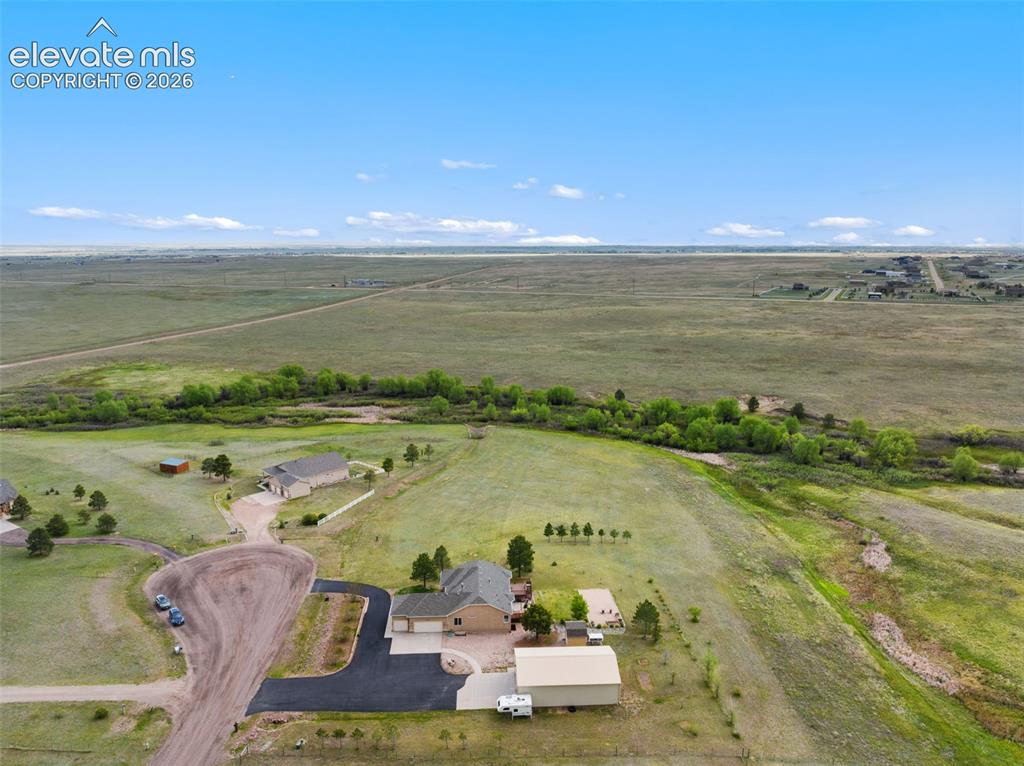 Image 42 of 49: Aerial view of the property with Black Squirrel Creek and green belt shown.