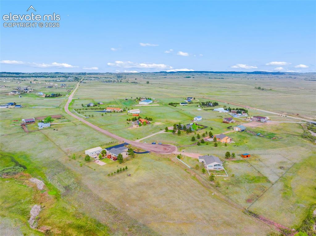 Image 44 of 49: Aerial view of the property with Black Squirrel Creek shown and cul-de-sac.