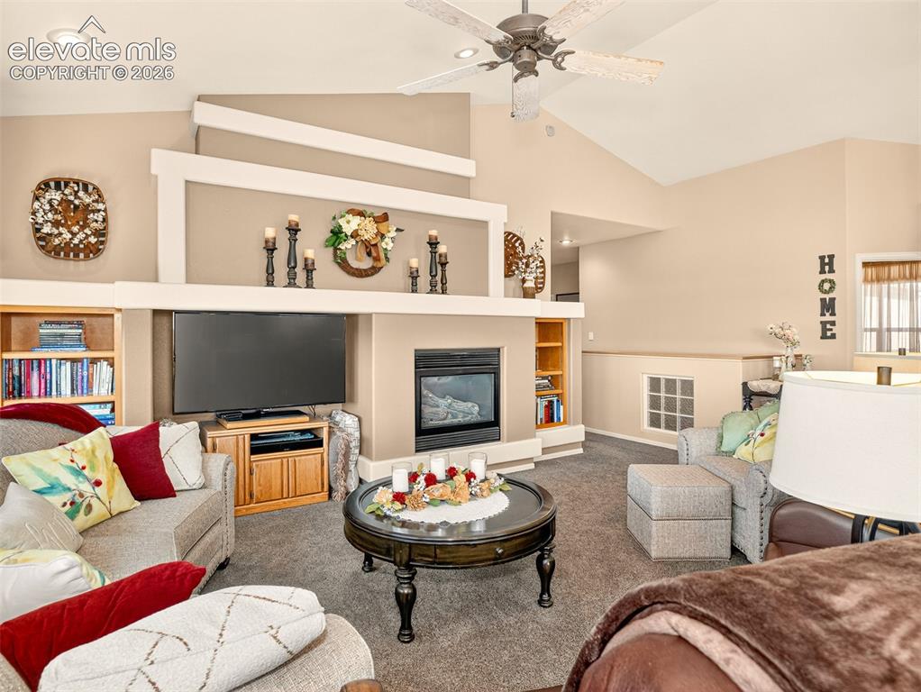 Image 6 of 49: Living room looking towards office and hallway leading to bedrooms, laundry
