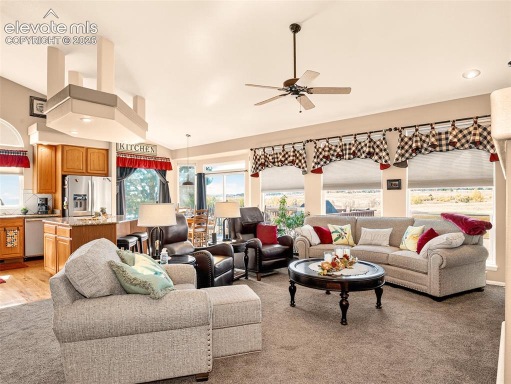Image 7 of 49: Large open concept living area with vaulted ceilings in the with living roo