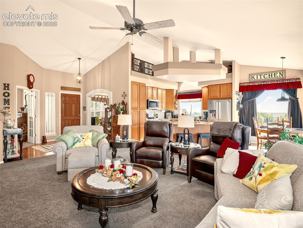 Image 8 of 49: Large open concept living area with vaulted ceilings in the with living roo