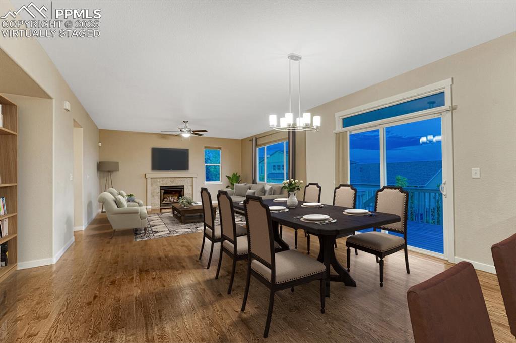 Image 11 of 50: Great room walks out to deck. Virtually staged.