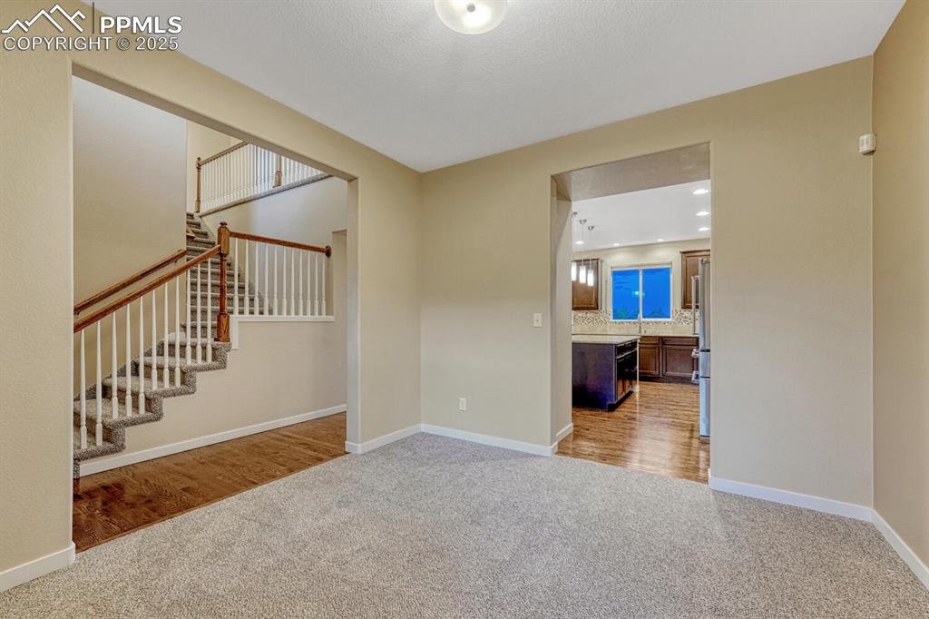 Image 14 of 50: Spare room with carpet floors and stairs