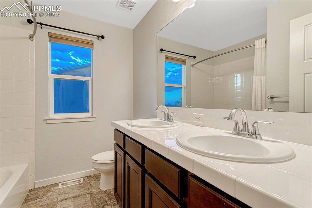 Image 24 of 50: Full hath bathroom with double sink vanity
