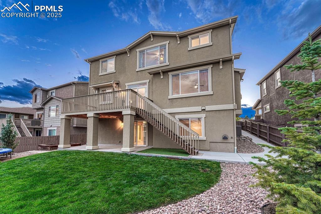 Image 35 of 50: Rear view of property with stairway, stucco siding, a patio, and a wooden d