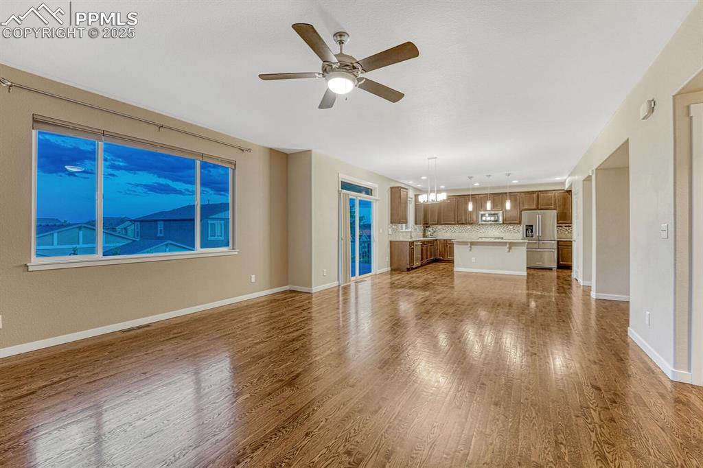 Image 41 of 50: Unfurnished living room featuring wood finished floors and ceiling fan