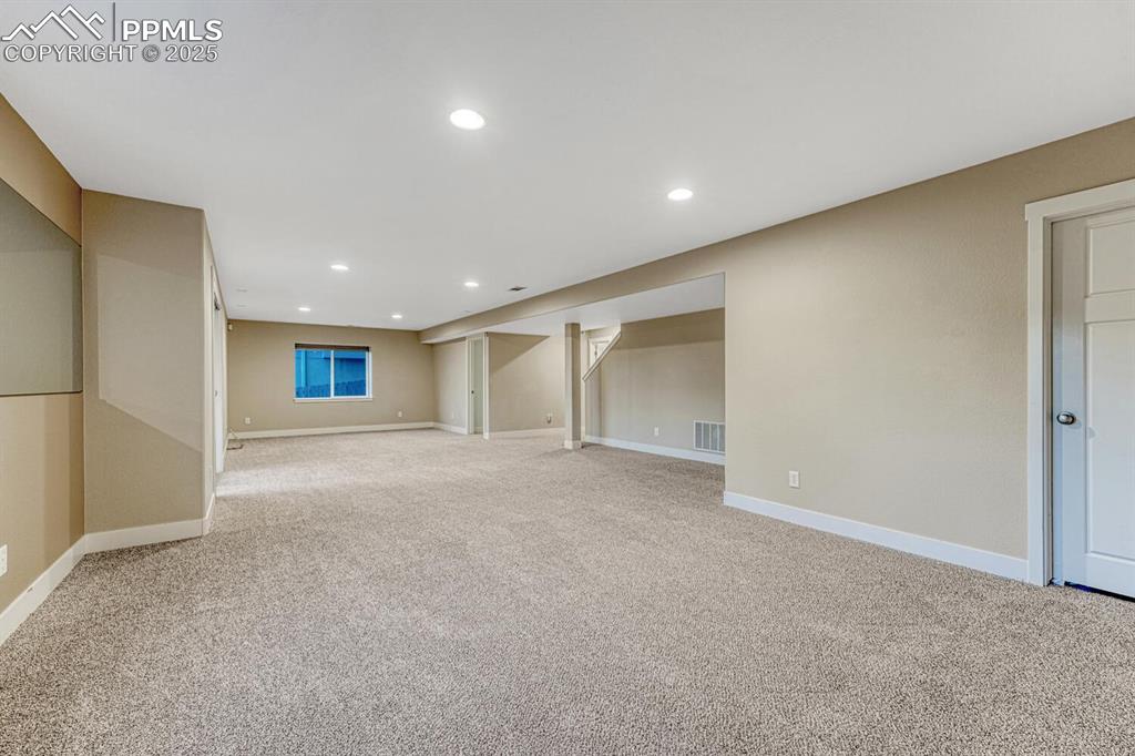 Image 48 of 50: Finished below grade area featuring light carpet and recessed lighting