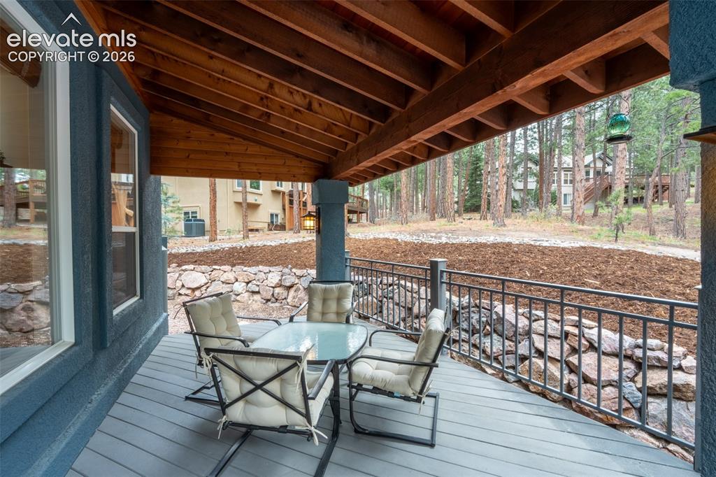 Image 38 of 49: Back deck off living room walk out - half covered/ half uncovered