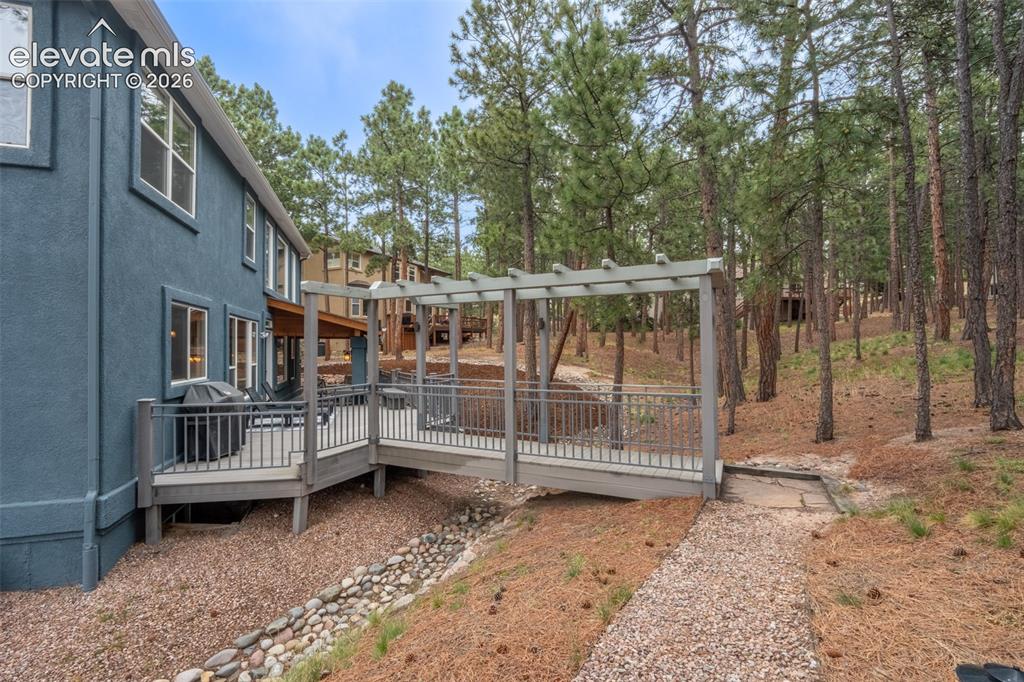 Image 41 of 49: Back deck off living room walk out - half covered/ half uncovered