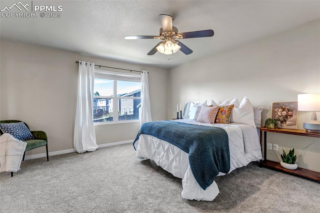 Image 18 of 37: Bedroom featuring carpet floors, ceiling fan, and a textured ceiling