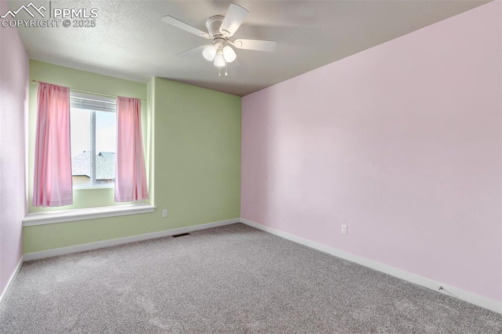 Image 26 of 37: Carpeted empty room featuring a textured ceiling and a ceiling fan