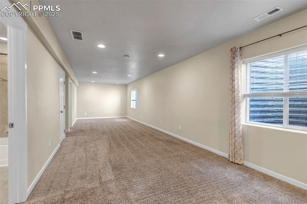 Image 30 of 37: Unfurnished room with light colored carpet and recessed lighting