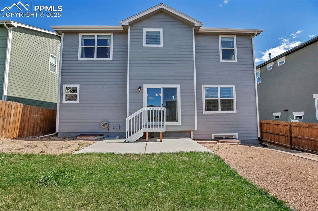 Image 34 of 37: Back of house featuring a fenced backyard and a patio