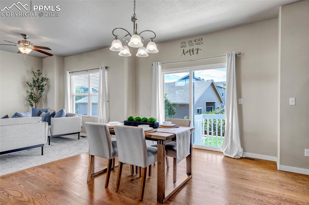 Image 9 of 37: Dining room featuring light wood finished floors, a chandelier, and ceiling